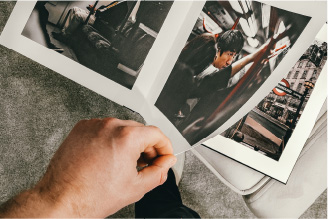 Authory homepage image of mans hand turning pages in a photobook