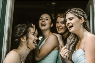 Authory homepage image of bridesmaids laughing and smiling happily